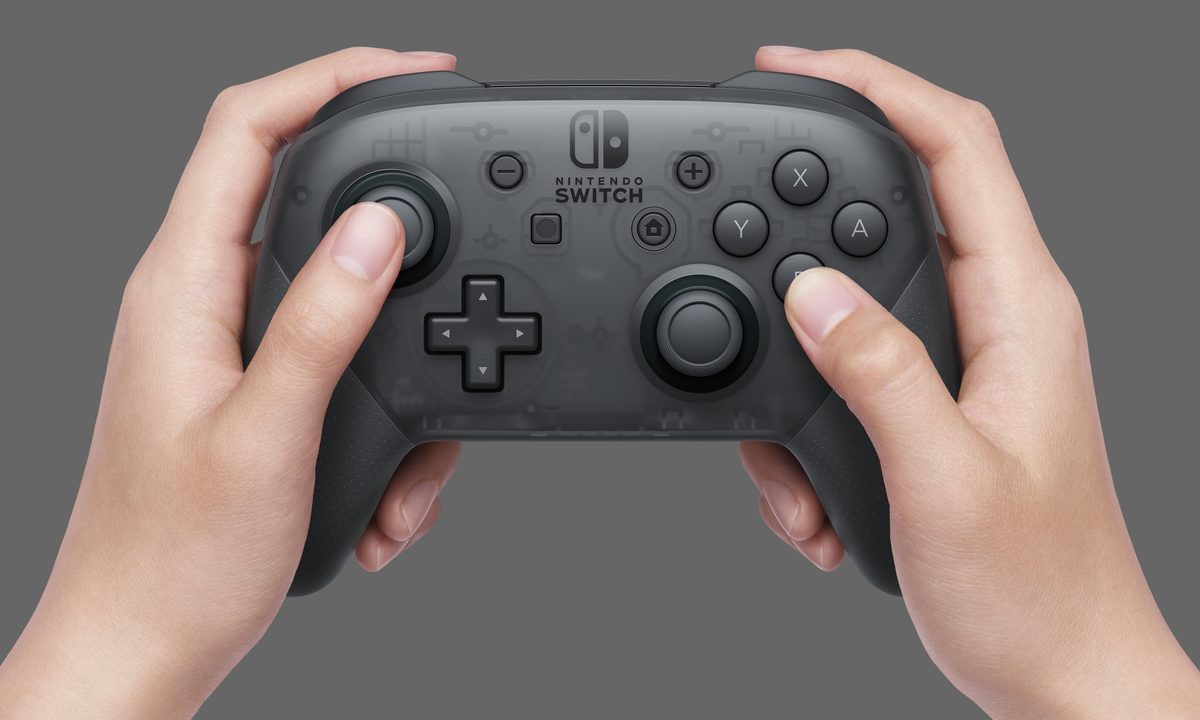 Hands holding Nintendo Switch Pro Controller.