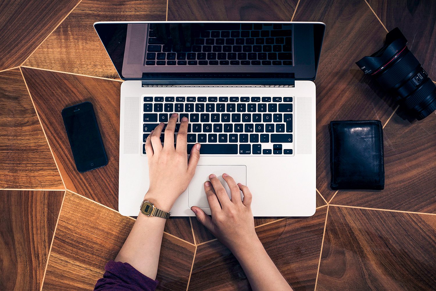 Hands typing on an MacBook