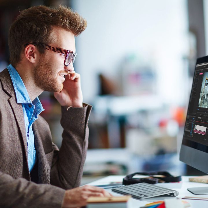 Man using Adobe Premiere Pro on iMac