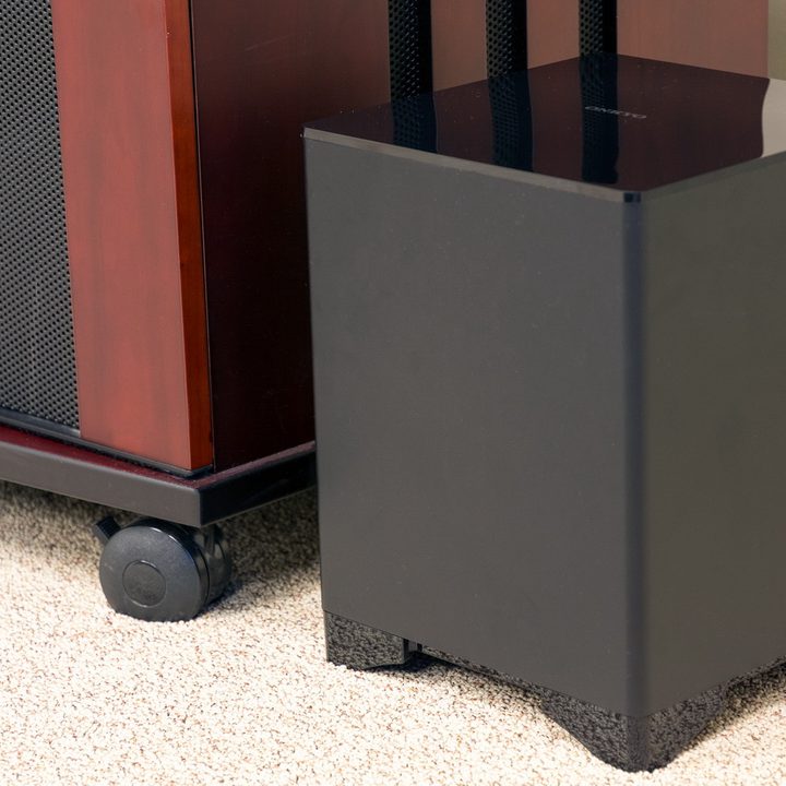 The Onkyo SBT-A500 soundbar's subwoofer sitting next to a TV stand.