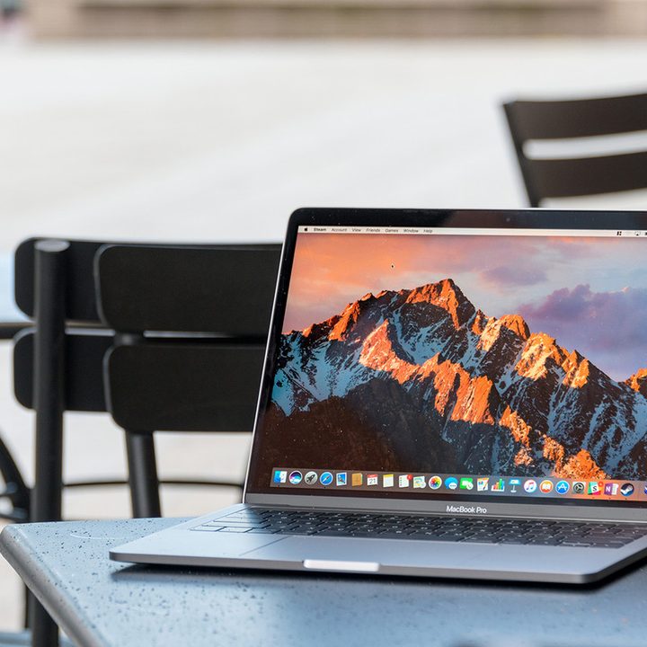 MacBook Pro sitting on a table outdoors