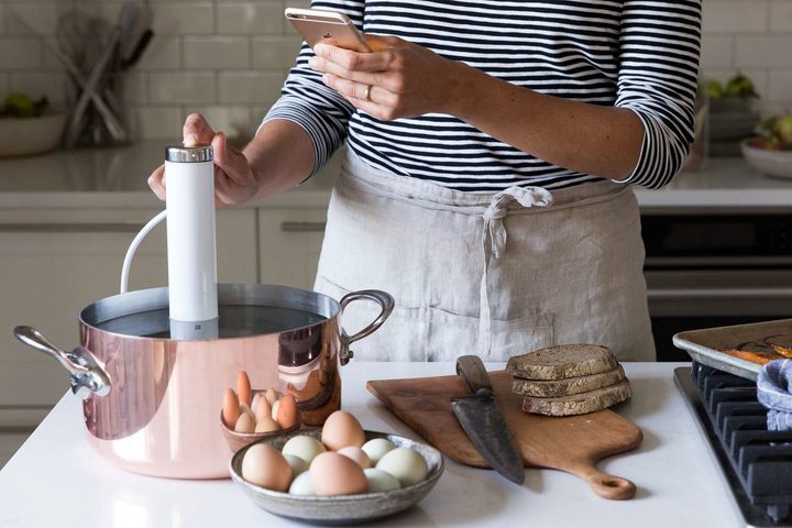 Woman using ChefSteps CS10001 Joule Sous Vide