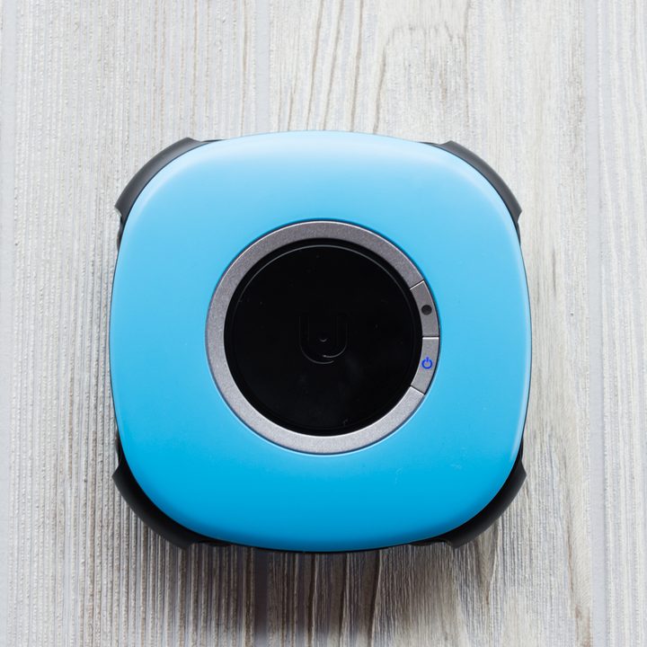 Vuze Camera sitting flat on a wood table