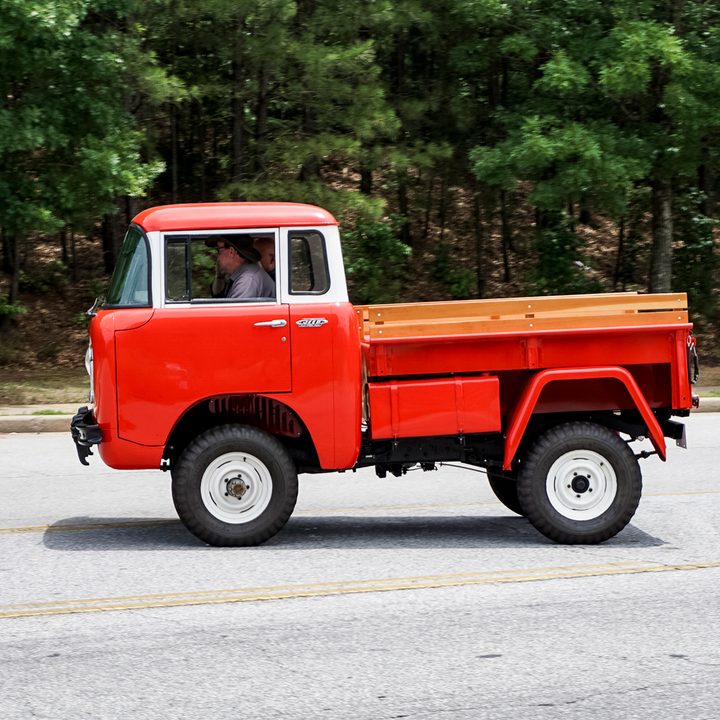 Side shot of candy-apple red classic jeep