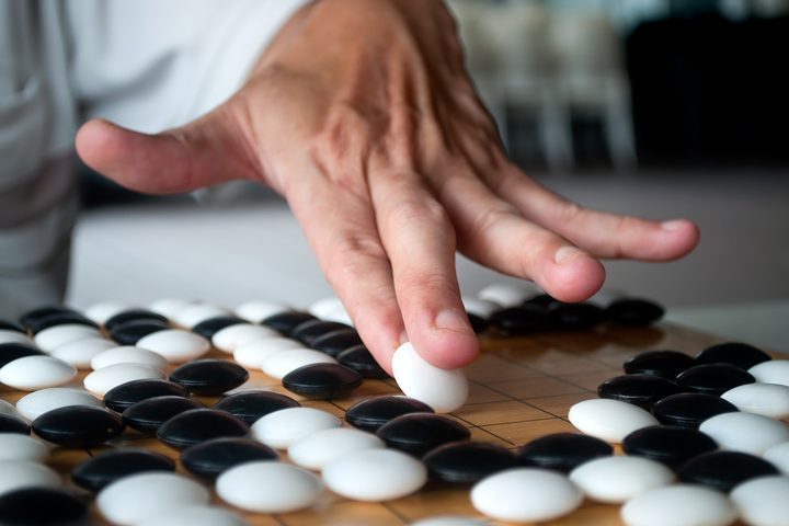 Close up of hand playing Go