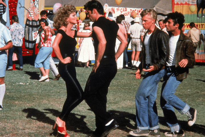 Danny and Sandy dance on the field in Grease.