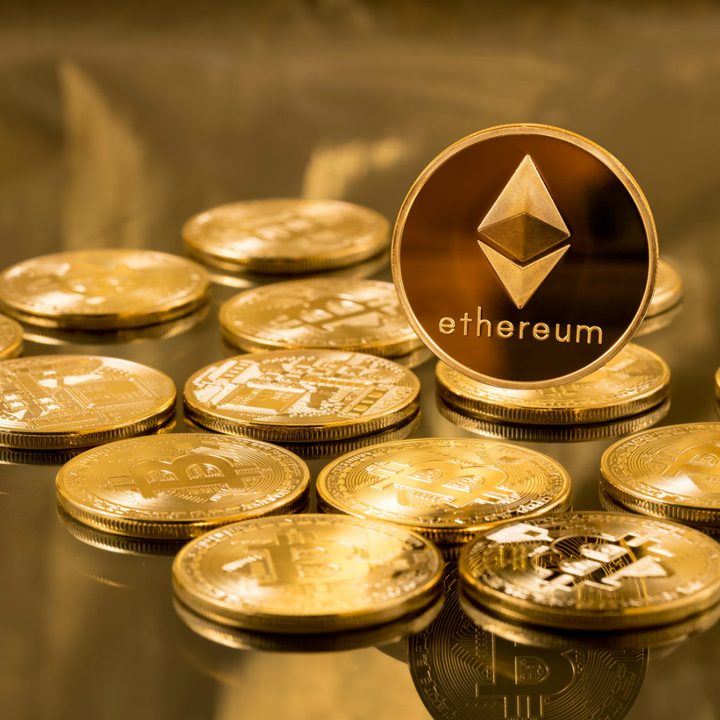Ethereum coins sitting on a desk.
