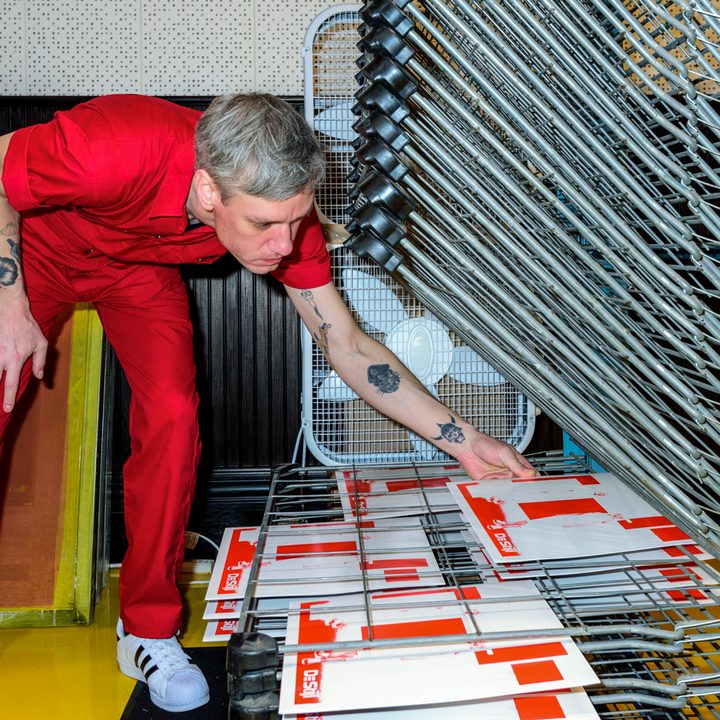 man-placing-new-covers-on-to-drying-rack