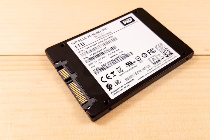 WD Blue 3D NAND SATA SSD sitting upside down on a table angled at 45 degrees