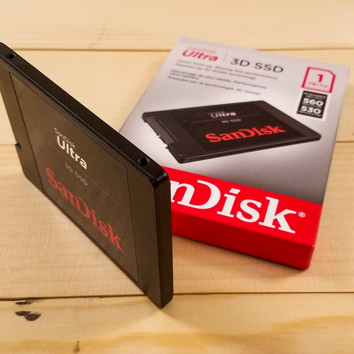 SanDisk Ultra 3D SSD sitting next to the box it comes in
