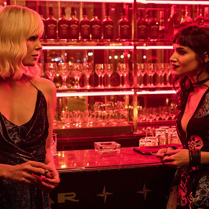 Two women stare at each other at the bar.