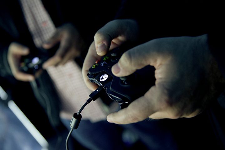 People playing video games with Xbox One controller Mike Ybarra