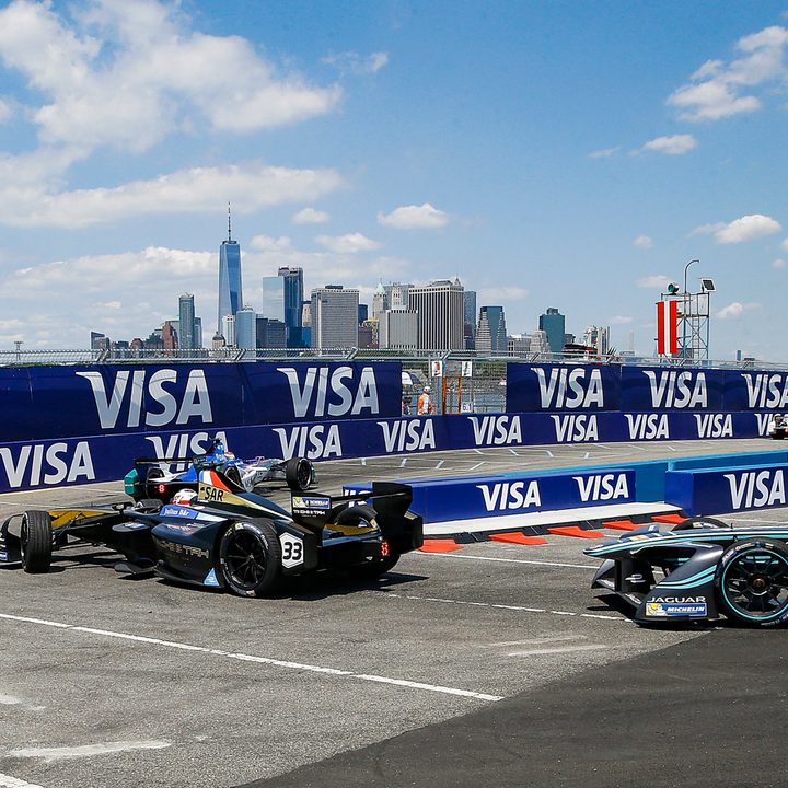 Formula E Racers taking a tight corner with downtown New York City in the background