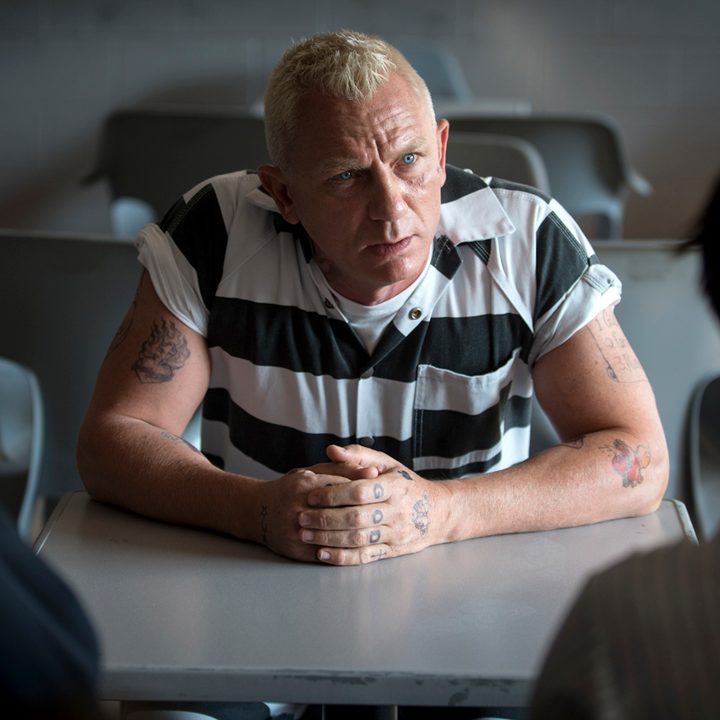 Joe Bang (Daniel Craig) talks to two visitors at a jail in Logan Lucky