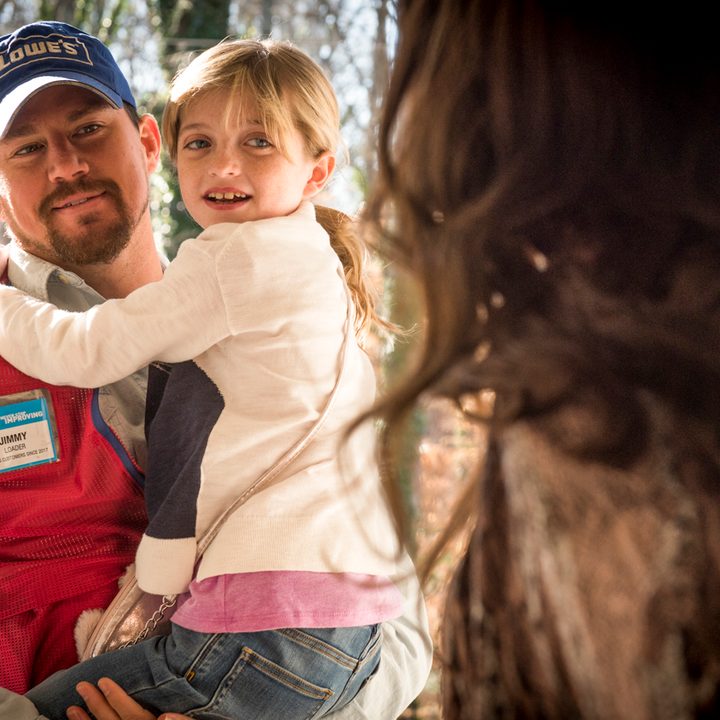 Channing Tatum holding up a little girl in "Logan Lucky."