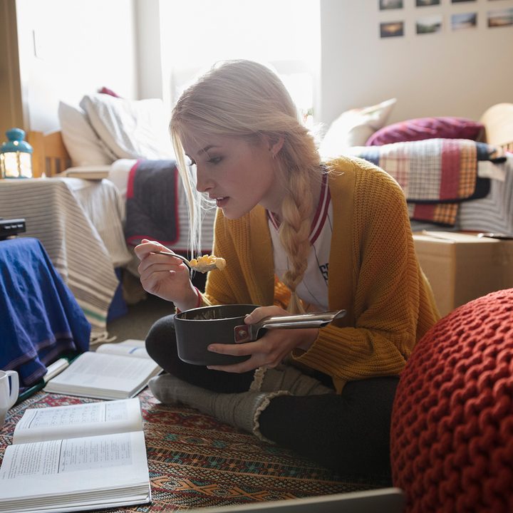A student eating mac and cheese while studying.