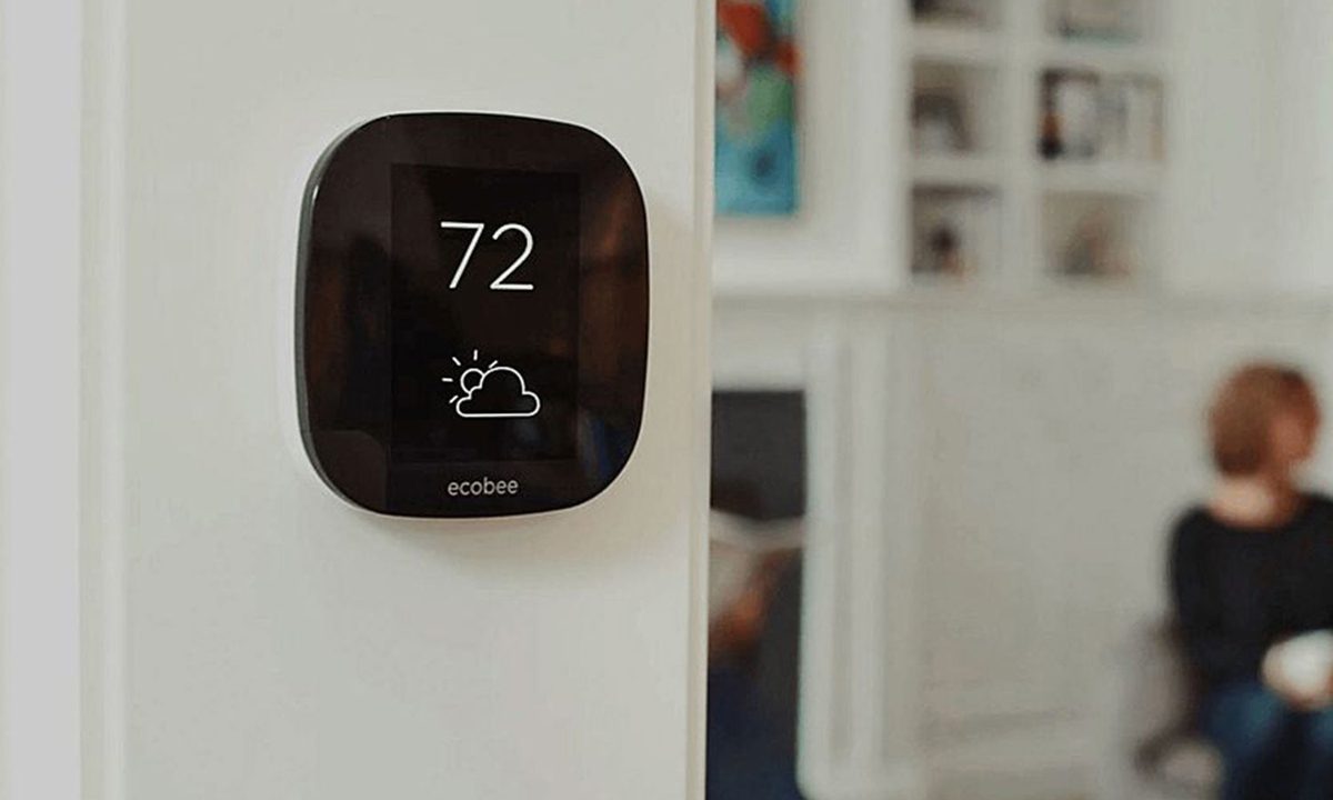 Ecobee4 smart thermostat mounted near living room.