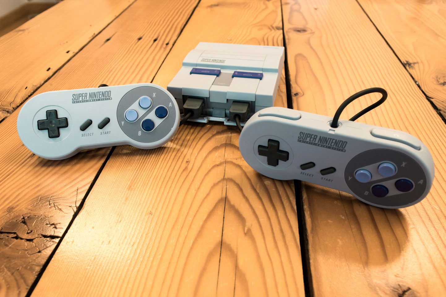 Both controllers in front of the SNES Classic Edition