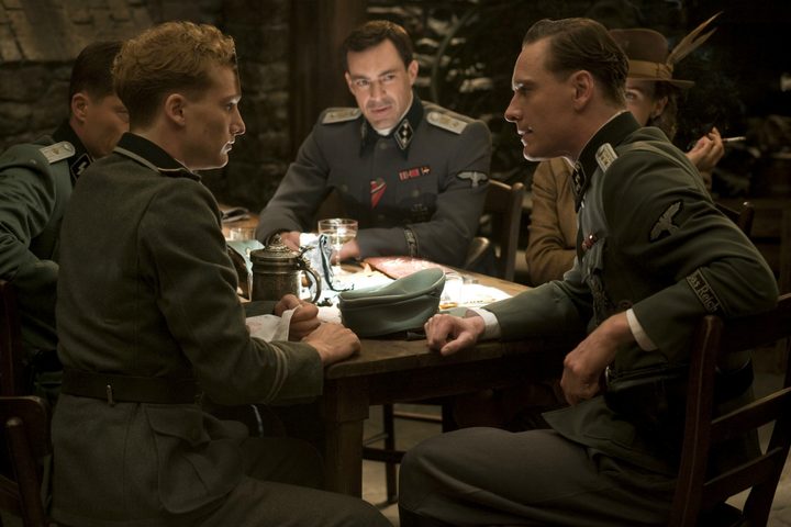 Men sit at a table in Inglourious Basterds.