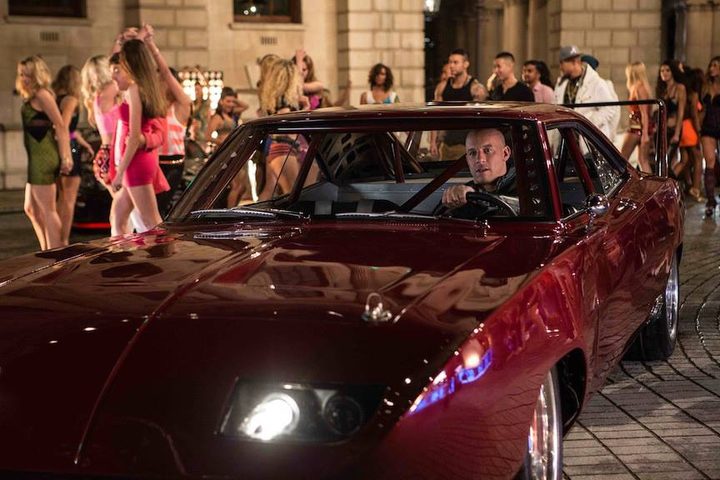 People crowd around a car in Fast & Furious 6.