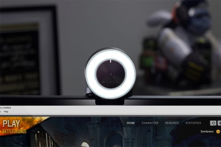 Razer webcam sitting on top of a monitor.