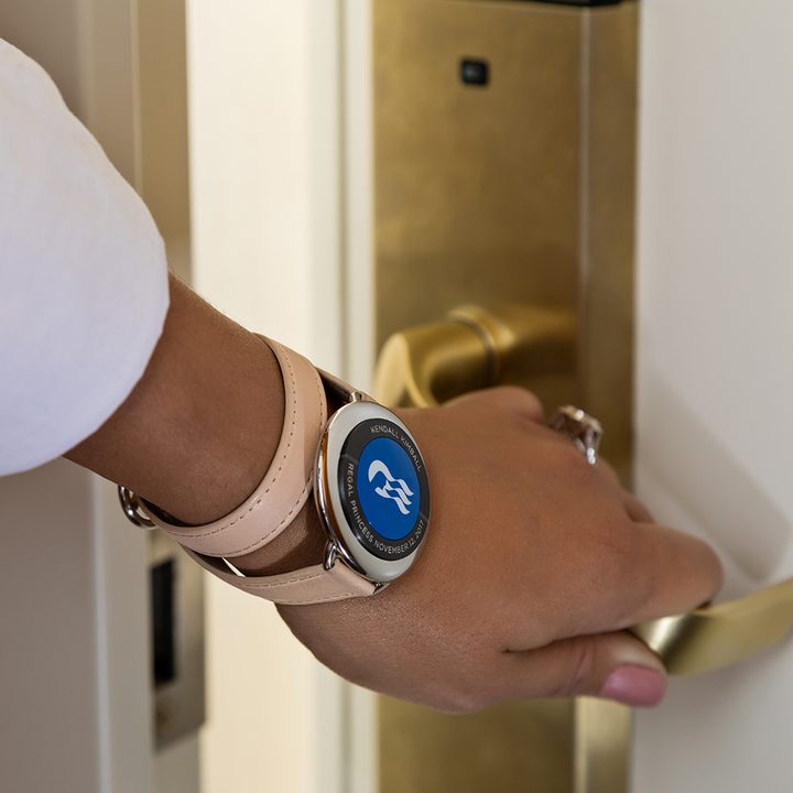 cruise ships turn to wearable tech create personalized experiences ocean medallion close up guest opening stateroom door