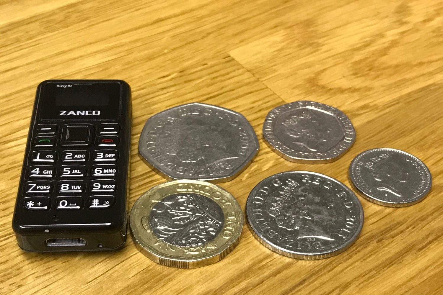 worlds tiniest cellphone kickstarter zanco tiny t1 with coins