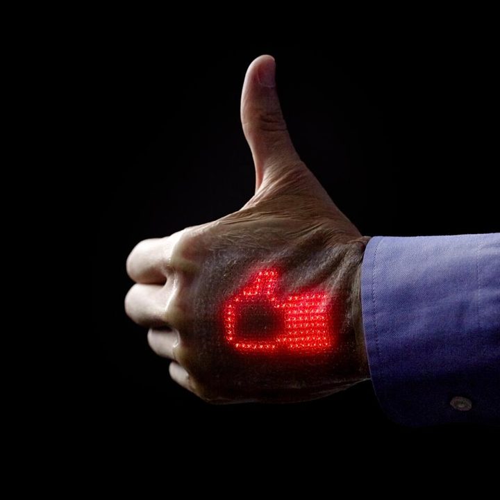 Skin display on a hand doing a thumbs up