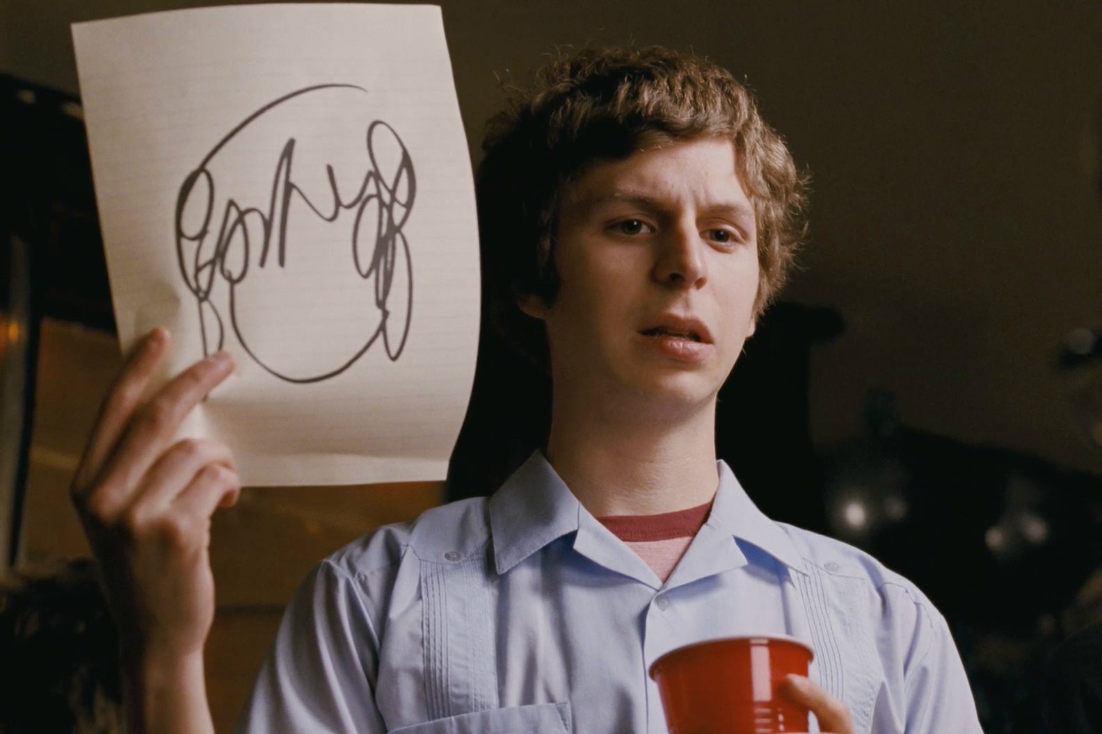 Michael Cera holding up a sketch in Scott Pilgrim vs. The World.
