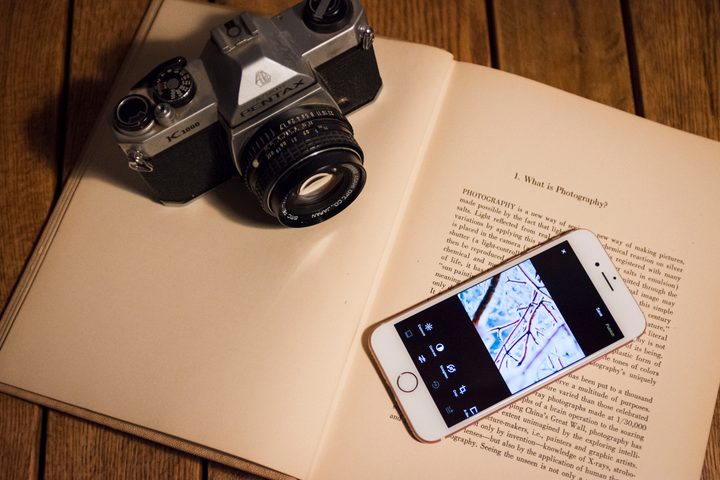 VSCO X Review — Phone and App on Book Next to Vintage Camera