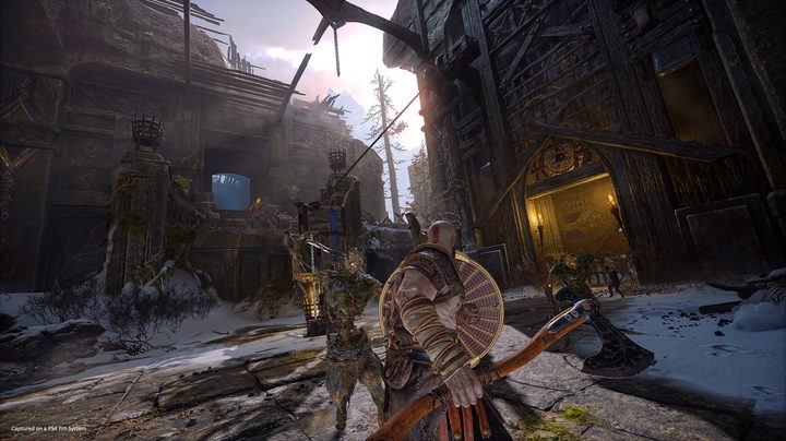 God of War Review | Kratos engaged in combat with enemies in some sort of fort