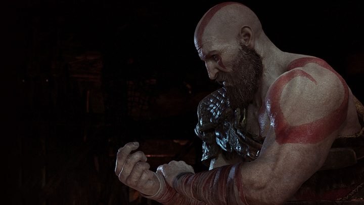 God of War Review | Kratos clenches his fist in a dark room