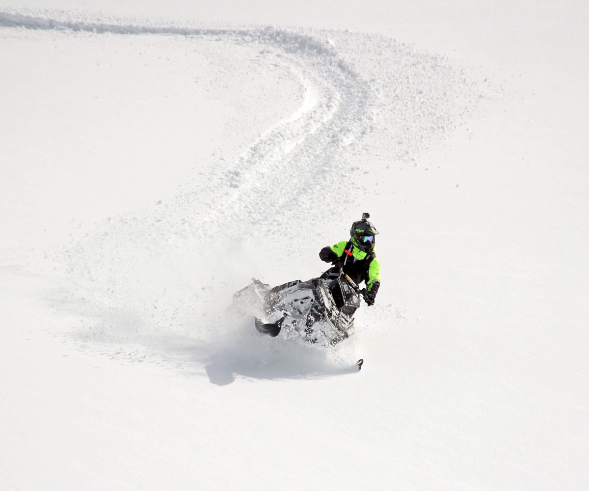 Snowmobiler wearing Highmark by Snowpulse avalanche airbag