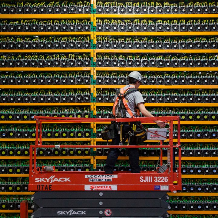 A technician inspects the backside of bitcoin mining at Bitfarms in Saint Hyacinthe.