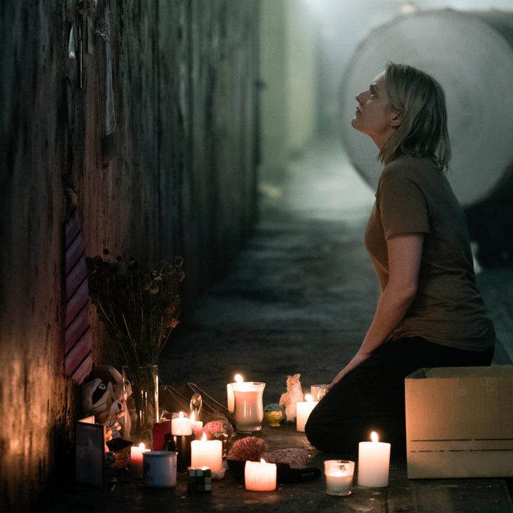 Offred praying in an altar in The Handmaid's Tale.