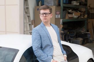 erik finman leaning against car