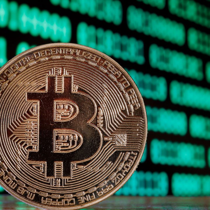 A Bitcoin over a digital background.