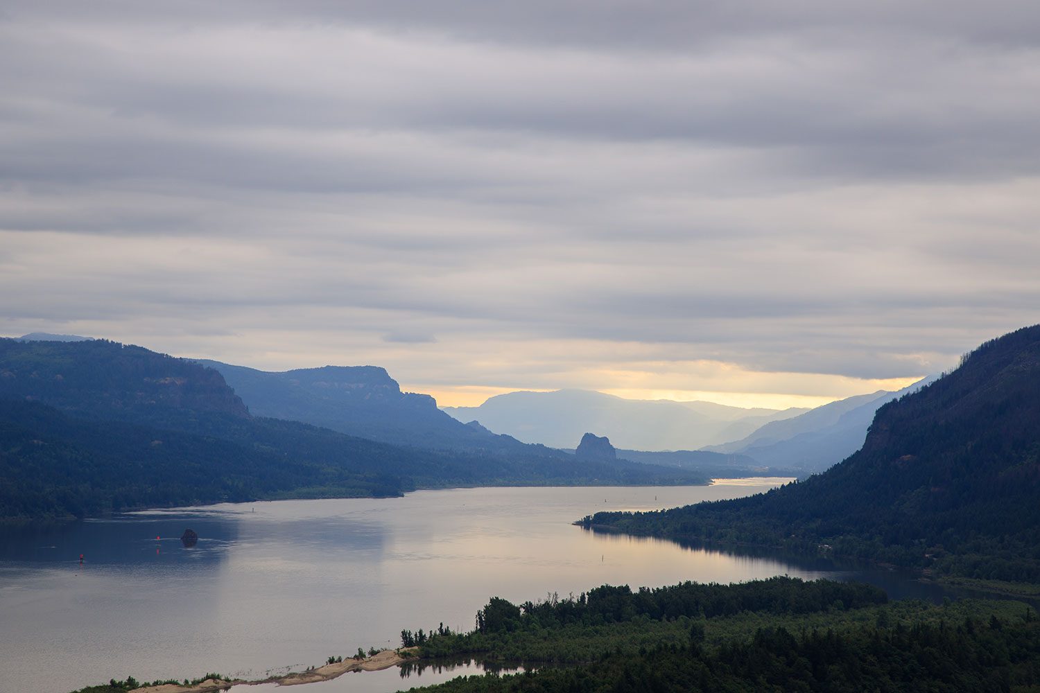 A landscape shot looking over a lake surrounded by mountains