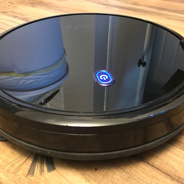 eufy RoboVac 11S sweeping a wood floor.