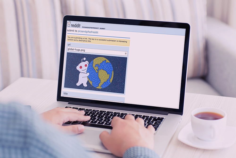 A person using Reddit on a Macbook.