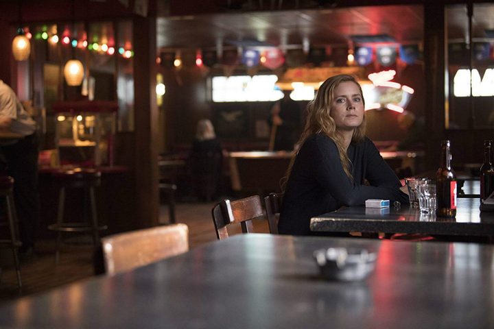 Amy Adams sitting in a bar in Sharp Objects (HBO)