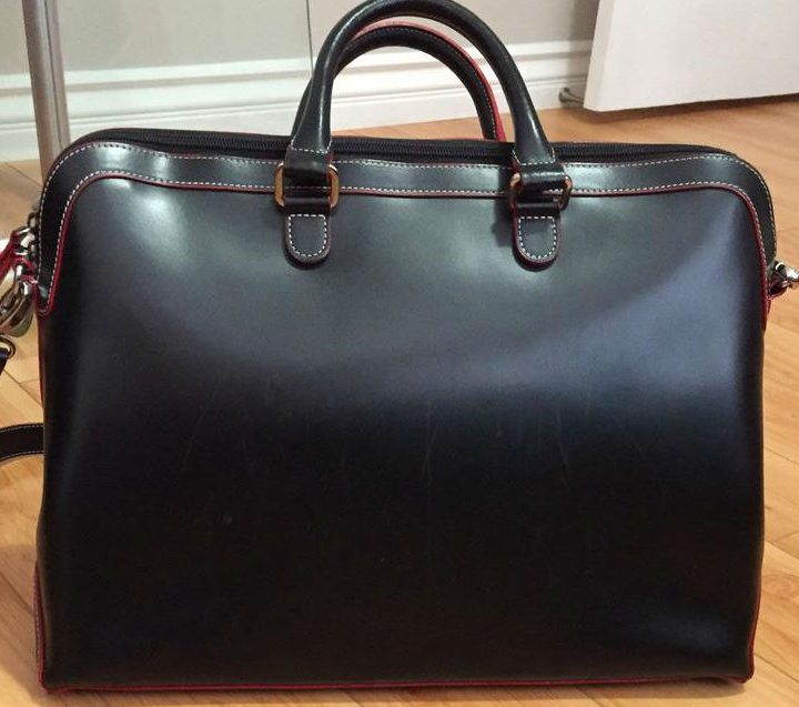 Lodis Accessories Audrey Brera Briefcase sitting on wooden floor.