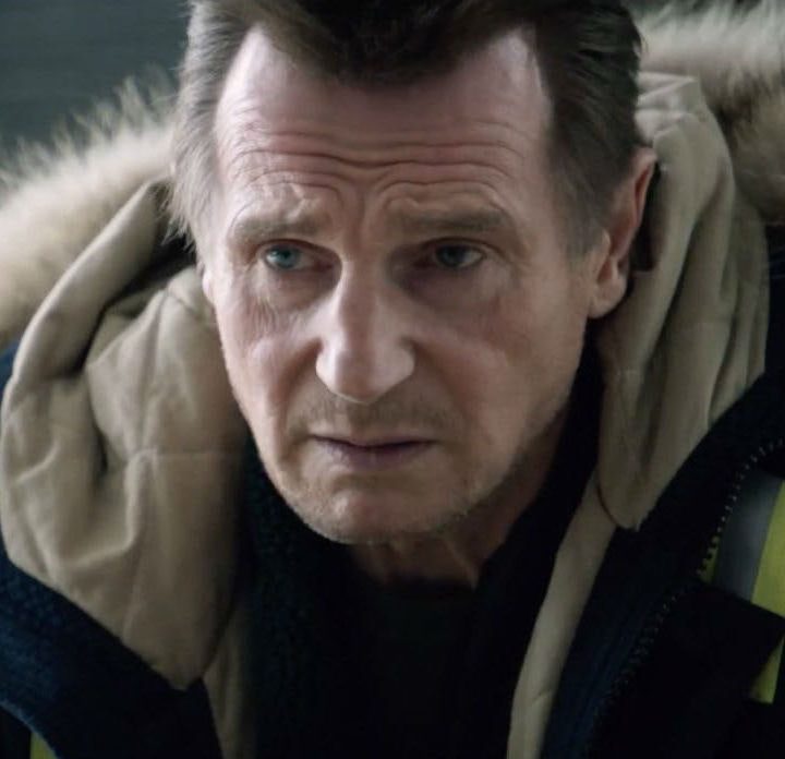 Liam Neeson stares while wearing a coat in Cold Pursuit.