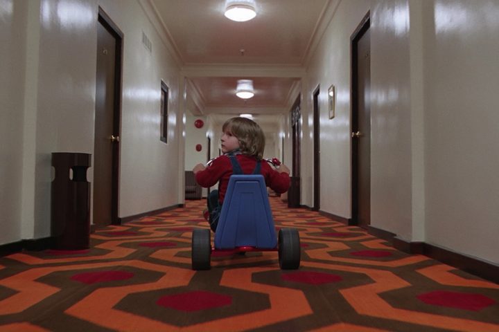 Danny riding his tricycle through The Overlook.