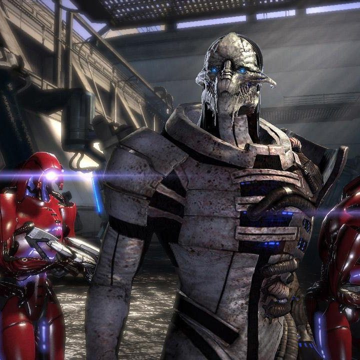Seran and red geth in a grey room.