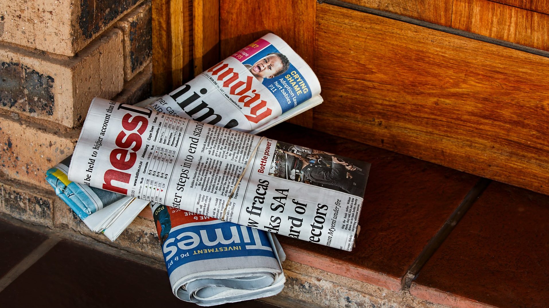 stock photo newspapers delivered at doorway