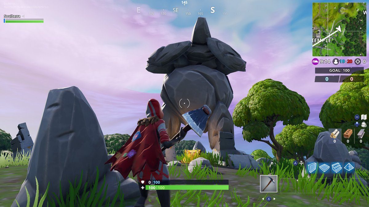 Fortnite Season 7 week 5 challenges search between a giant rock man crowned tomato and encircled tree
