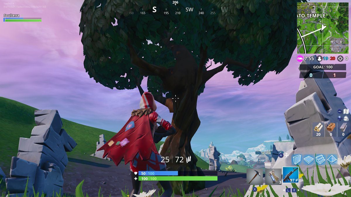 Fortnite Season 7 week 5 challenges search between a giant rock man crowned tomato and encircled tree