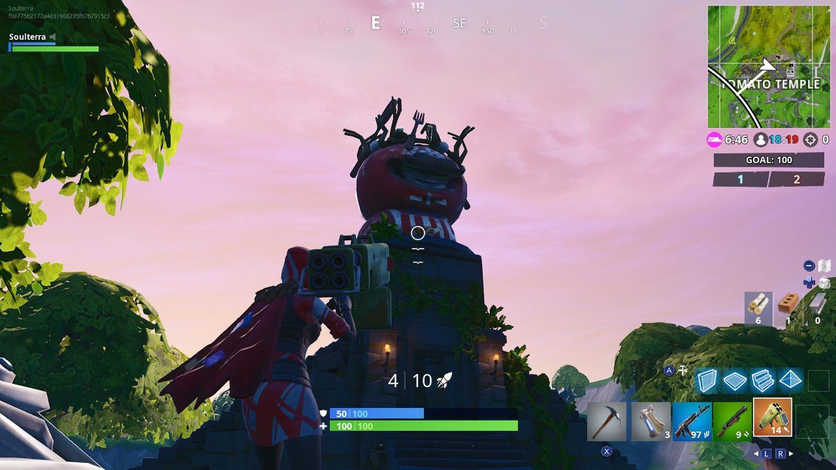 Fortnite Season 7 week 5 challenges search between a giant rock man crowned tomato and encircled tree