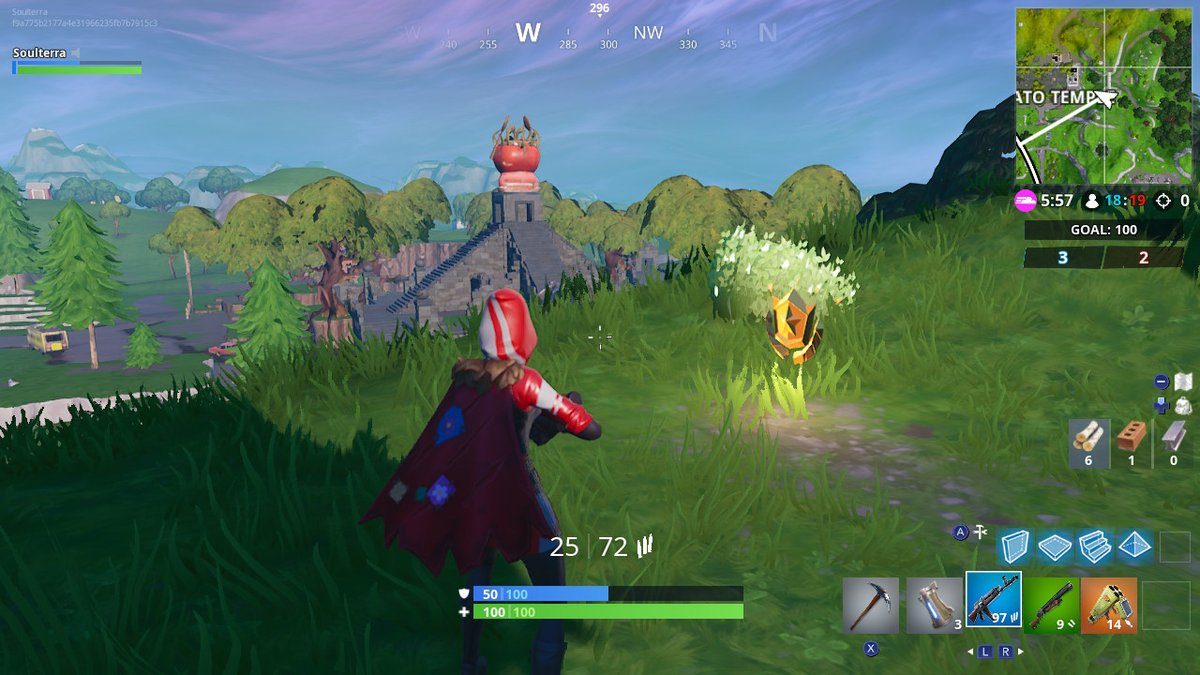 Fortnite Season 7 week 5 challenges search between a giant rock man crowned tomato and encircled tree